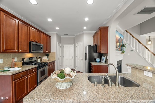 7873 Cape Charles Dr, Raleigh, NC 27617 - kitchen featuring stainless steel appliances, recessed lighting, decorative backsplash, light stone countertops, and a fireplace