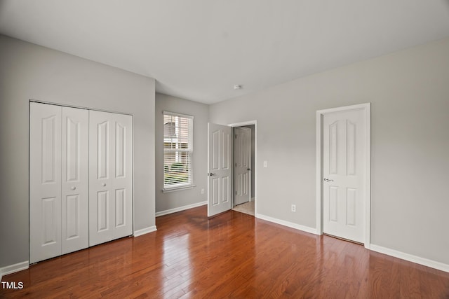 7873 Cape Charles Dr, Raleigh, NC 27617 - unfurnished bedroom with wood finished floors and a closet