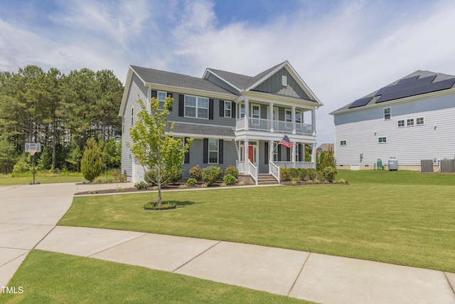 470 E Wellesley Dr, Clayton, NC 27520 - view of front of property with a porch, a balcony, concrete driveway, and a front lawn