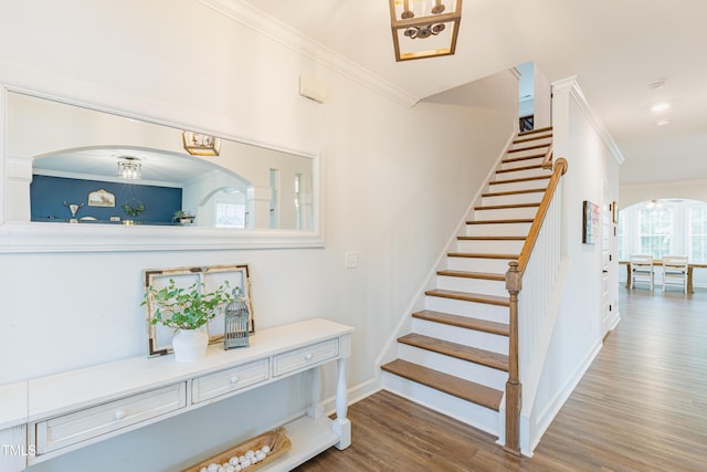 470 E Wellesley Dr, Clayton, NC 27520 - staircase featuring arched walkways, wood finished floors, ornamental molding, and a chandelier