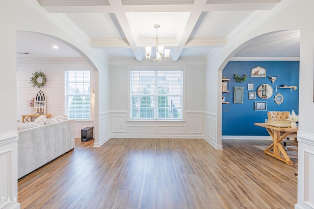 470 E Wellesley Dr, Clayton, NC 27520 - entryway with a chandelier, beamed ceiling, light wood-style flooring, coffered ceiling, and a wainscoted wall