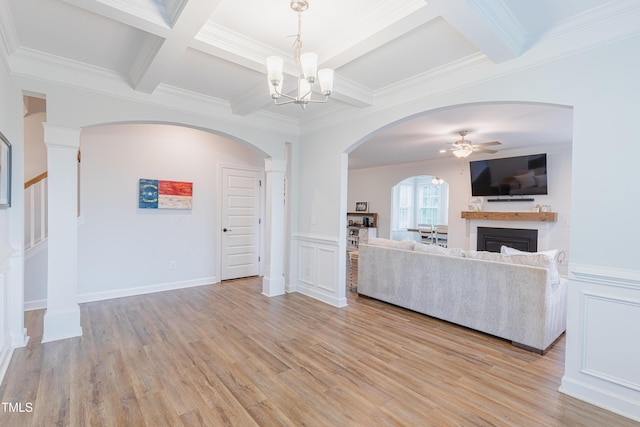 470 E Wellesley Dr, Clayton, NC 27520 - unfurnished living room featuring coffered ceiling, beam ceiling, a ceiling fan, a fireplace, and arched walkways