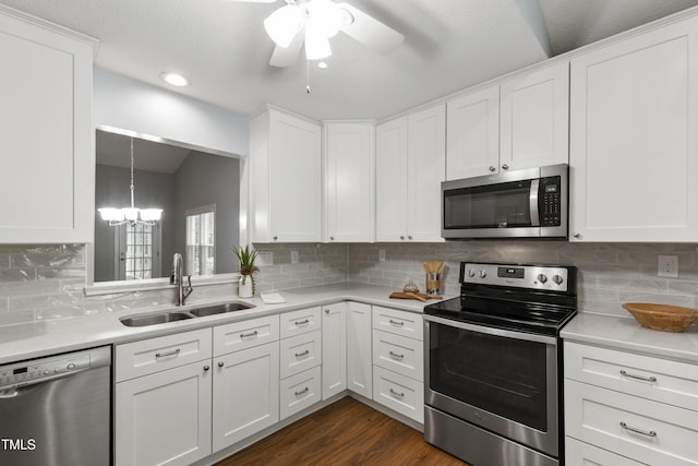 115 Heatherwood Dr, Apex, NC 27502 - kitchen with stainless steel appliances, a sink, light countertops, a chandelier, and ceiling fan