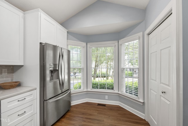 115 Heatherwood Dr, Apex, NC 27502 - kitchen with stainless steel refrigerator with ice dispenser, light countertops, baseboards, vaulted ceiling, and white cabinetry