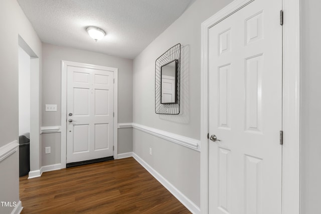 115 Heatherwood Dr, Apex, NC 27502 - foyer entrance with dark wood-style flooring, a textured ceiling, and baseboards