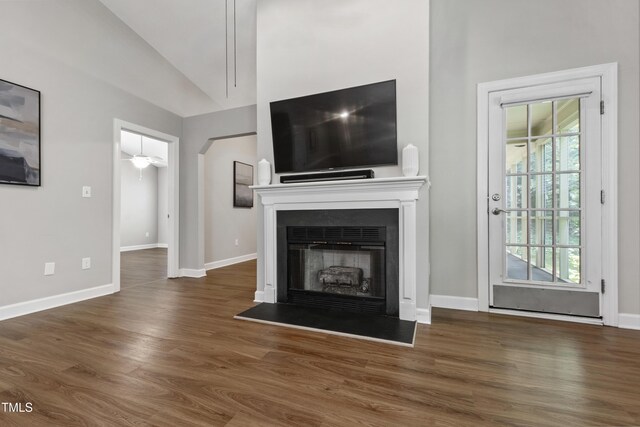 115 Heatherwood Dr, Apex, NC 27502 - unfurnished living room with wood finished floors, vaulted ceiling, plenty of natural light, and baseboards