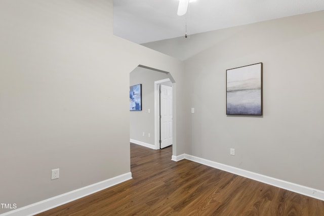 115 Heatherwood Dr, Apex, NC 27502 - spare room with arched walkways, baseboards, dark wood-type flooring, ceiling fan, and lofted ceiling
