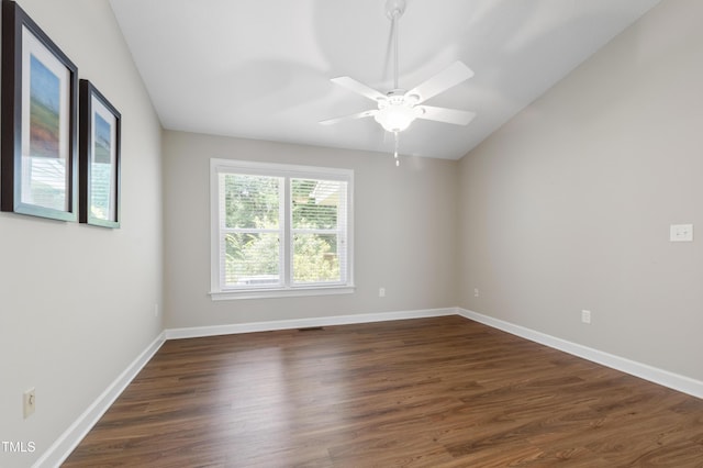 115 Heatherwood Dr, Apex, NC 27502 - spare room featuring dark wood-style floors, lofted ceiling, ceiling fan, and baseboards