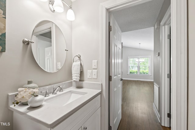 115 Heatherwood Dr, Apex, NC 27502 - bathroom featuring wood finished floors, vanity, and vaulted ceiling