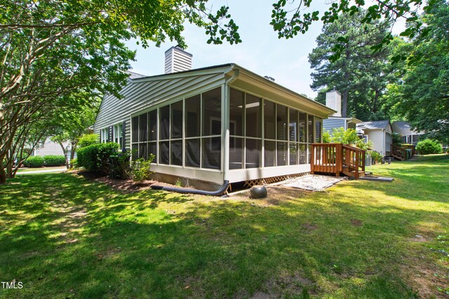 115 Heatherwood Dr, Apex, NC 27502 - back of property featuring a chimney, a sunroom, and a lawn