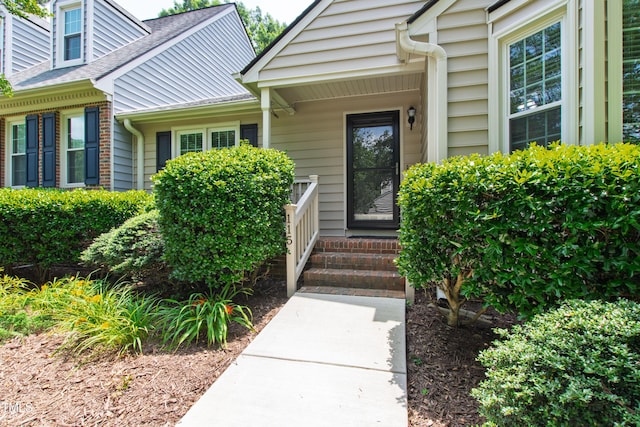 115 Heatherwood Dr, Apex, NC 27502 - property entrance featuring roof with shingles and brick siding