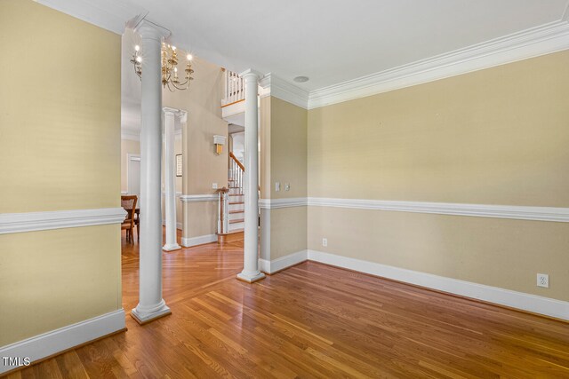 206 W Stoneybrook Ct, Benson, NC 27504 - empty room with ornamental molding, wood finished floors, decorative columns, baseboards, and stairs