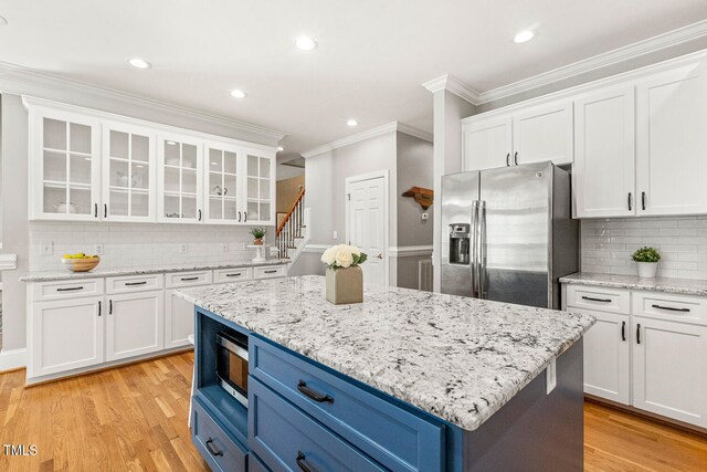 206 W Stoneybrook Ct, Benson, NC 27504 - kitchen featuring appliances with stainless steel finishes, blue cabinets, ornamental molding, white cabinets, and recessed lighting