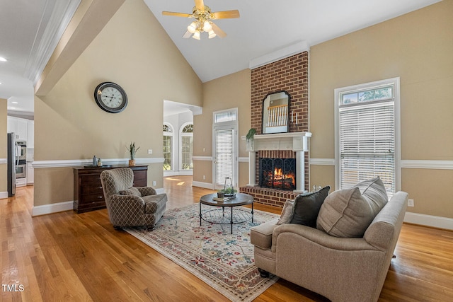 206 W Stoneybrook Ct, Benson, NC 27504 - living area featuring a fireplace, plenty of natural light, light wood-type flooring, and high vaulted ceiling
