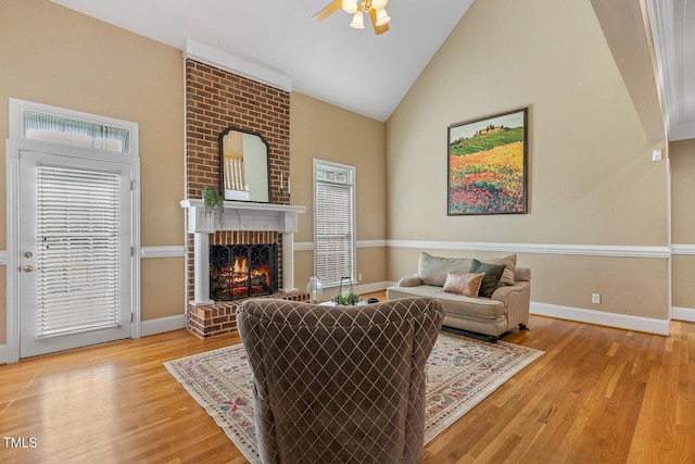 206 W Stoneybrook Ct, Benson, NC 27504 - living room with light wood-type flooring, ceiling fan, a fireplace, plenty of natural light, and high vaulted ceiling