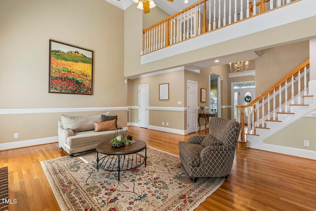 206 W Stoneybrook Ct, Benson, NC 27504 - living room with baseboards, wood finished floors, stairs, a high ceiling, and ornamental molding