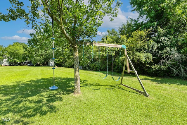 206 W Stoneybrook Ct, Benson, NC 27504 - view of green lawn with a playground and view of wooded area