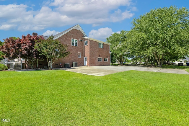 206 W Stoneybrook Ct, Benson, NC 27504 - back of property featuring brick siding, central air condition unit, a yard, and stairway