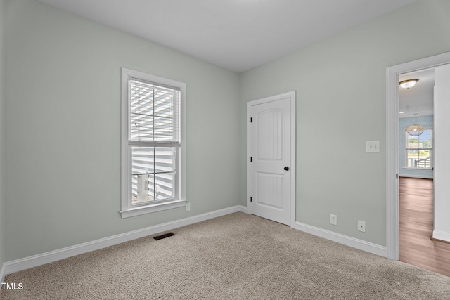 4333 US-117 Hwy, Wilson, NC 27893 - unfurnished bedroom featuring multiple windows, carpet flooring, and baseboards
