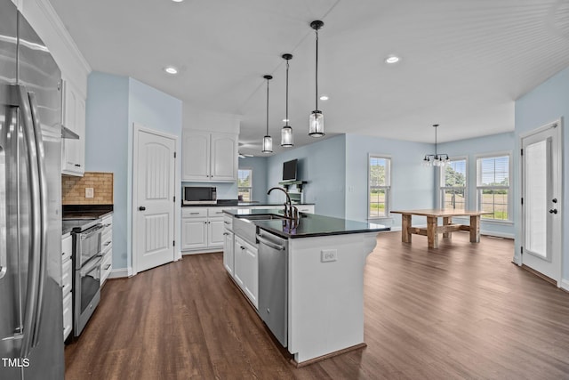 4333 US-117 Hwy, Wilson, NC 27893 - kitchen featuring stainless steel appliances, dark countertops, a sink, dark wood-type flooring, and backsplash