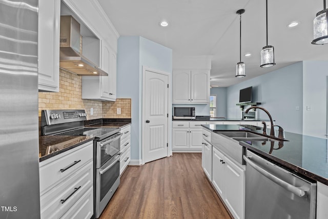 4333 US-117 Hwy, Wilson, NC 27893 - kitchen featuring appliances with stainless steel finishes, wall chimney range hood, a sink, white cabinetry, and dark wood-type flooring