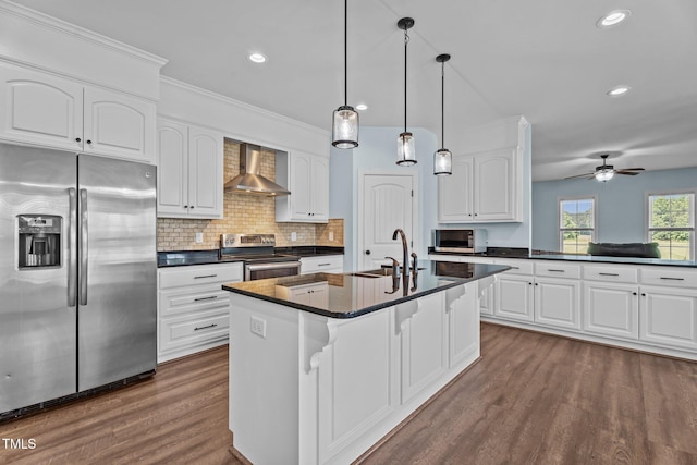 4333 US-117 Hwy, Wilson, NC 27893 - kitchen with stainless steel appliances, a sink, wall chimney exhaust hood, dark countertops, and dark wood-style flooring