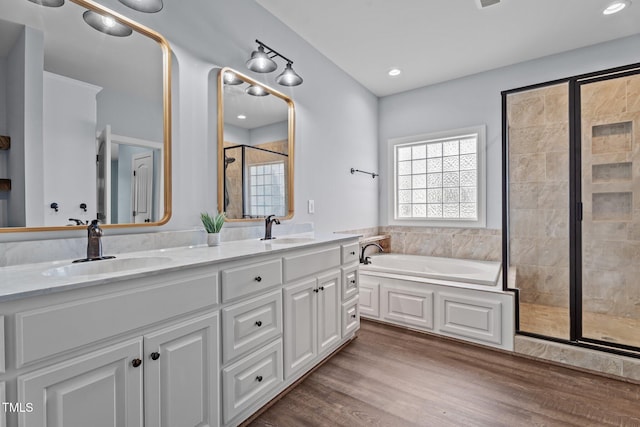 4333 US-117 Hwy, Wilson, NC 27893 - bathroom featuring a shower stall, double vanity, a garden tub, wood finished floors, and recessed lighting