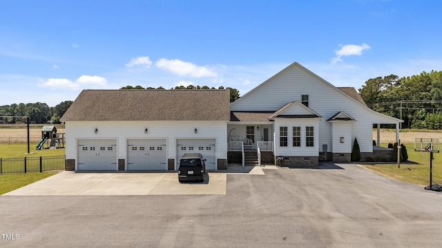 4333 US-117 Hwy, Wilson, NC 27893 - view of front of property with asphalt driveway, crawl space, an attached garage, a shingled roof, and a playground