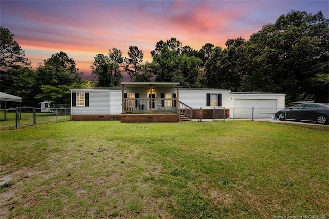 566 Quail Run Rd, Lumberton, NC 28358 - manufactured / mobile home with covered porch, crawl space, a garage, and view of scattered trees
