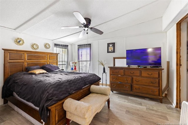 566 Quail Run Rd, Lumberton, NC 28358 - bedroom with light wood-style flooring, a textured ceiling, and a ceiling fan