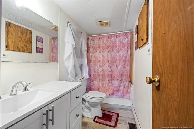 566 Quail Run Rd, Lumberton, NC 28358 - bathroom featuring vanity, toilet, wood finished floors, and shower / tub combo
