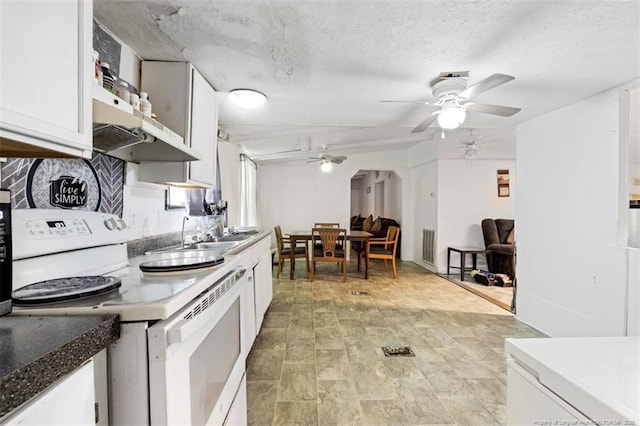 566 Quail Run Rd, Lumberton, NC 28358 - kitchen with electric range, ceiling fan, white cabinets, a sink, and a textured ceiling