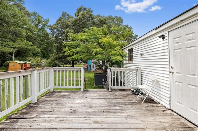 566 Quail Run Rd, Lumberton, NC 28358 - wooden terrace with a playground and view of wooded area