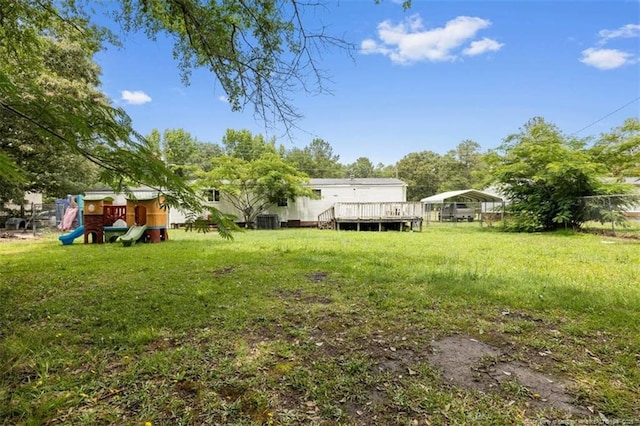 566 Quail Run Rd, Lumberton, NC 28358 - view of yard featuring a detached carport, a playground, a wooden deck, and cooling unit