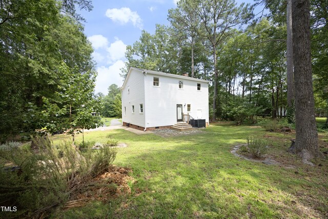 409 Glaive Dr, Durham, NC 27703 - rear view of house with a yard, a chimney, and crawl space