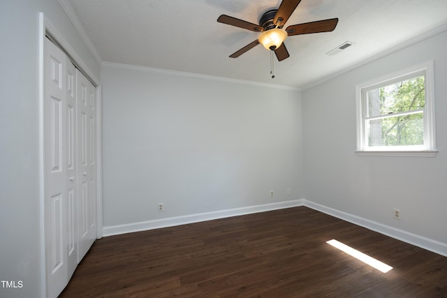 409 Glaive Dr, Durham, NC 27703 - unfurnished bedroom featuring dark wood-style floors, crown molding, a closet, and ceiling fan