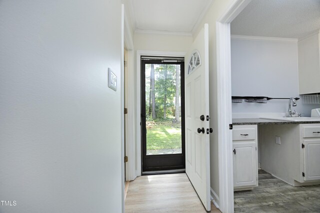 409 Glaive Dr, Durham, NC 27703 - doorway with ornamental molding and light wood-style flooring