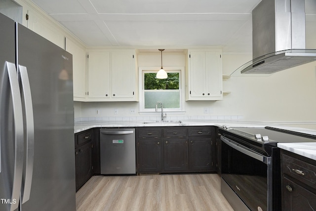 409 Glaive Dr, Durham, NC 27703 - kitchen featuring appliances with stainless steel finishes, wall chimney range hood, light wood-type flooring, open shelves, and white cabinetry