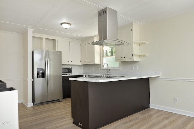 409 Glaive Dr, Durham, NC 27703 - kitchen with stainless steel appliances, a peninsula, island range hood, light wood-style floors, and light countertops