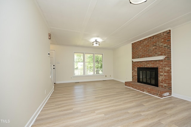 409 Glaive Dr, Durham, NC 27703 - unfurnished living room with light wood-style flooring and a brick fireplace