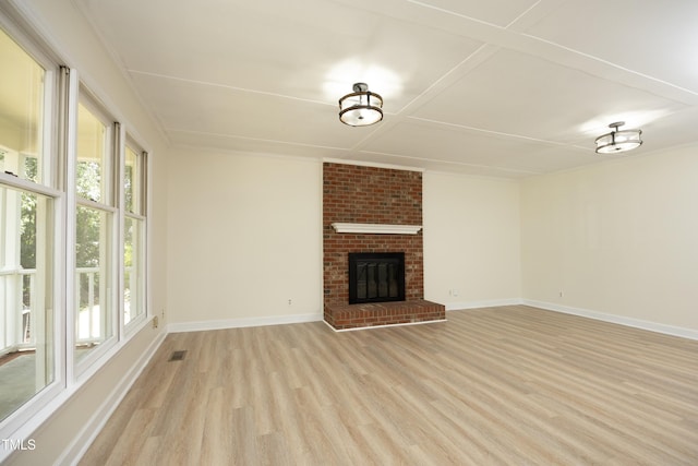 409 Glaive Dr, Durham, NC 27703 - unfurnished living room featuring light wood-style floors and a brick fireplace