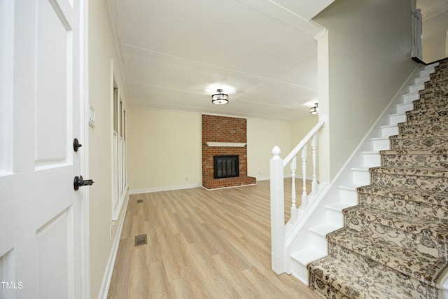 409 Glaive Dr, Durham, NC 27703 - entrance foyer with light wood-type flooring, stairway, and a fireplace