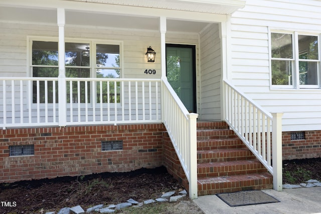 409 Glaive Dr, Durham, NC 27703 - view of exterior entry featuring crawl space and covered porch