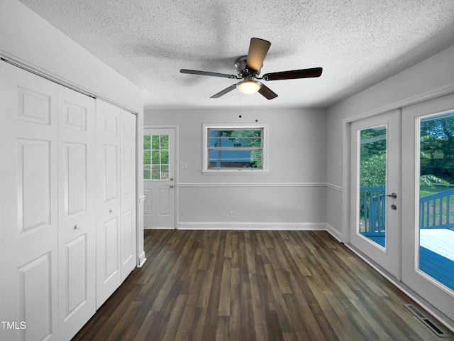 1914 Adams Pl, Hillsborough, NC 27278 - unfurnished bedroom featuring access to exterior, a textured ceiling, dark wood-style floors, a closet, and ceiling fan