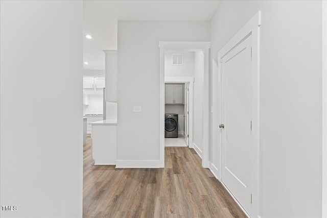 857 Whistable Ave, Wake Forest, NC 27587 - hallway featuring washer / dryer, wood finished floors, baseboards, and recessed lighting