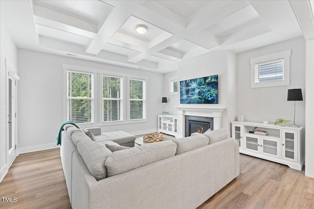 857 Whistable Ave, Wake Forest, NC 27587 - living room with wood finished floors, plenty of natural light, beam ceiling, a lit fireplace, and coffered ceiling