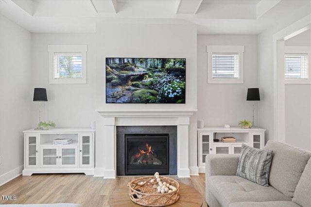 857 Whistable Ave, Wake Forest, NC 27587 - living area with light wood finished floors, plenty of natural light, a fireplace with flush hearth, and beamed ceiling