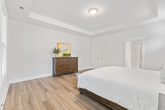 857 Whistable Ave, Wake Forest, NC 27587 - bedroom with a raised ceiling, light wood finished floors, and baseboards