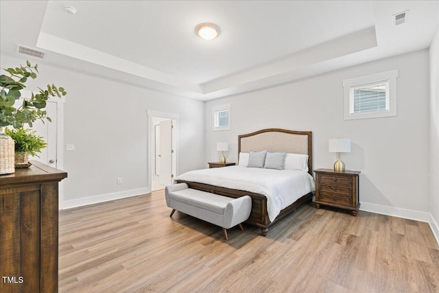 857 Whistable Ave, Wake Forest, NC 27587 - bedroom featuring a tray ceiling, light wood-style floors, and baseboards