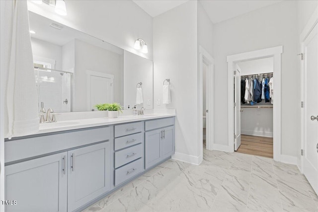 857 Whistable Ave, Wake Forest, NC 27587 - full bathroom with a shower stall, double vanity, marble finish floors, baseboards, and a spacious closet